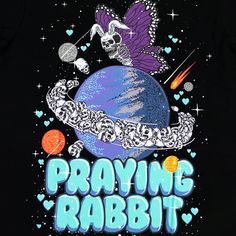 a t - shirt with the words praying rabbit on it and an image of a skull flying