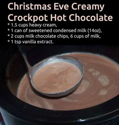 a bowl filled with hot chocolate next to a spoon