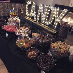 the candy bar has many different types of candies and chocolates on display for everyone to enjoy