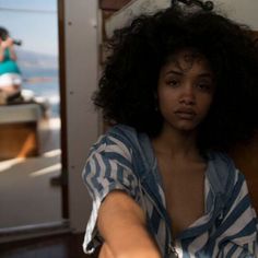 a woman with long hair sitting on a boat