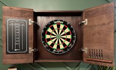 a dart board mounted to the side of a wooden cabinet