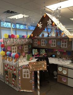 an office cubicle decorated with gingerbread house decorations