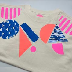 Geometric pattern hand screenprinted Boxy shape Women's T-shirt.  *Please note I print to order so allow 10 days for the order to be processed* Made from 100% Organic ring-spun combed cotton 185gsm   Screenprinted by myself in Brighton using water based inks. *AVAILABLE IN SIZES SMALL, MEDIUM, LARGE AND XL. PLEASE REFER TO THE SIZE CHART IN PHOTOS FOR MEASUREMENTS* The t-shirt is 'boxy shape'  T-shirt colour is 'White Mist' which is a soft off white very pale cream colour in a flattering 'boxy' Fun Pink T-shirt With Screen Print, Casual Spring T-shirt With Abstract Print, Neon Casual T-shirt With Screen Print, Color Block Graphic Tee Cotton T-shirt, Unisex Pink Screen Print T-shirt, Pink Organic Cotton T-shirt With Graphic Print, Coral And Blue, Geo Pattern, Shirt Colour