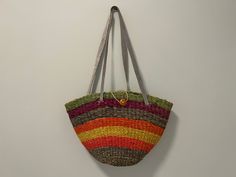 "This rainbow sisal bag is gorgeous! Colors include blue, pink, yellow, orange, purple and green. Straps are light blue leather. Very sturdy design and well-made.  Dimensions:  Height (body): 11\" Width (top) 16\"  Width (base): 7\"  Depth (body): 5\" Handle Drop Length: 13\" Condition: Great vintage condition." Retro Multicolor Shoulder Bag For Beach, Multicolor Retro Shoulder Bag For Beach, Multicolor Shoulder Bag With Leather Handles For Vacation, Multicolor Summer Shoulder Bag For Market, Retro Multicolor Vacation Bags, Multicolor Woven Satchel Beach Bag, Multicolor Shoulder Bag With Adjustable Strap For Market, Multicolor Handwoven Straw Satchel Bag, Summer Multicolor Straw Bag With Leather Handles