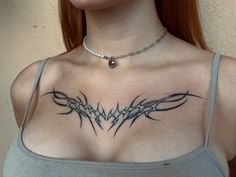 a woman with a tattoo on her chest