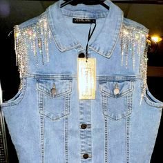 a light blue jean jacket with silver sequins on it