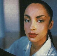 a close up of a person wearing a white shirt and red lipstick on her face