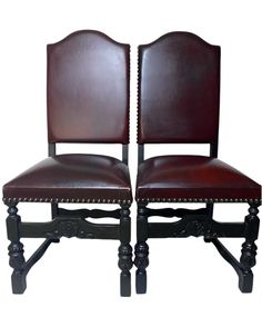 two brown leather chairs with wooden legs