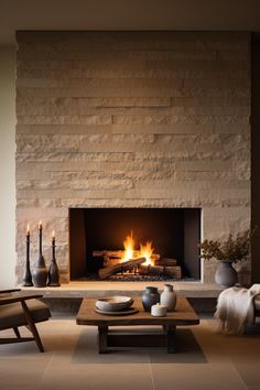 a living room filled with furniture and a fire place in front of a stone wall