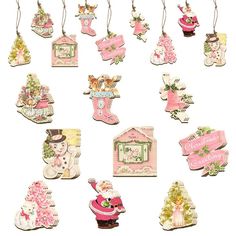 a collection of christmas ornaments hanging from strings on a white background with clippings attached to each ornament