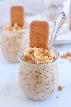 two small jars filled with food on top of a table