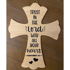 a wooden cross that says trust in the lord with all your heart