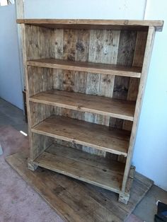 an old wooden bookcase sitting on the floor