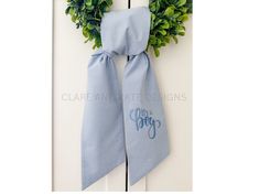 a blue and white door with a wreath on it that says, the grigs