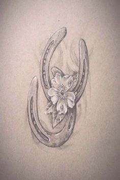 a drawing of a horseshoe with flowers on the side and an antelope's tail