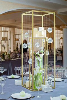 a table set with plates, silverware and candles