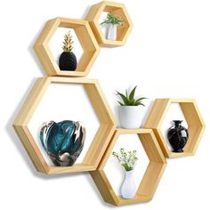 three hexagonal shelves with plants and vases on them, one is made out of wood