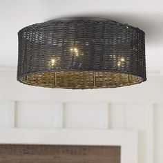 a wicker light fixture hanging from the ceiling