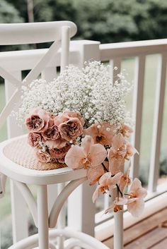 a bouquet of flowers sitting on top of a white chair