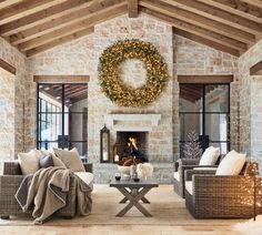 a living room filled with furniture and a wreath hanging on the wall over a fire place