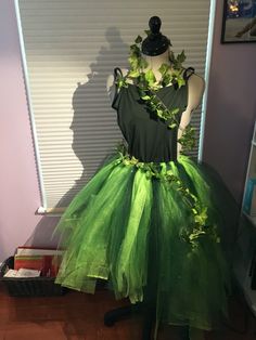 a dress made out of green tulle and leaves