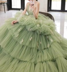 Step into a world of elegance and sophistication with our Sage Green Tiered Tulle Gown. This exquisite ball gown features a stunning tiered tulle skirt that creates a dramatic and voluminous silhouette, perfect for making a grand entrance. The corset back adds a touch of timeless charm while ensuring a perfect fit. The gown's sage green hue exudes a sense of tranquility and grace, making it an ideal choice for any formal occasion. Delicate embellishments and intricate detailing enhance the gown' Prom Dress Green, Simple Satin Wedding Dress, Tulle Long Prom Dress, Nontraditional Wedding Dress, Sweet 16 Dress, Tiered Tulle Skirt, Fairy Wedding Dress, Gothic Wedding Dress, Green Tulle