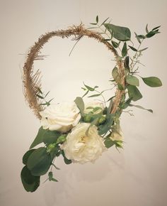 a wreath with white flowers and greenery