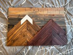 three different wood pieces sitting on top of a bed