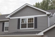 a gray house with white trim and black shutters