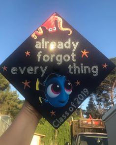 someone is holding up a graduation cap with the words already forgot every thing on it