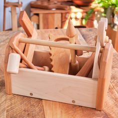 a wooden box filled with lots of different types of woodworking tools on top of a table