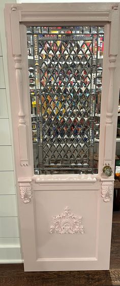 a white cabinet sitting on top of a hard wood floor