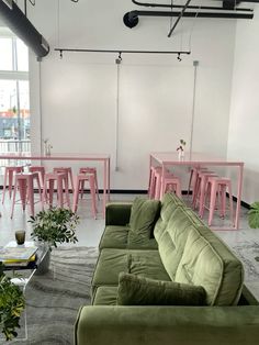 a living room filled with furniture and pink tables