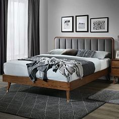 a bed sitting on top of a wooden floor next to a wall mounted radiator