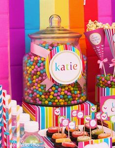 colorful candy bar with cupcakes, candies and lollipops on the table