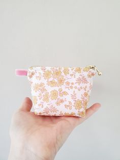 "100% Cotton. Lightweight. From the world famous Liberty Fabrics with a silk-like touch, unique print quality and striking color vibrancy. This mini pouch is great size for a couple of small items. Size is 4.25\"W / 3\"H / 1.5\"D (10.5cm / 7cm / 4cm) Flat bottom shape. Fabric is Liberty of London Tana Lawn / Exclusive print. Imported from UK. The pouch opens with golden color zipper.(High quality YKK zipper) It comes with a velvet ribbon on one side.(color is pale pink) Lined inside with pretty Pink Coin Purse With Removable Pouch, Pink Pouch With Zipper Pocket, Pink Pouch Coin Purse With Zipper, Trendy Pink Coin Purse With Zipper, Pink Pouch Coin Purse As Gift, Pink Pouch Coin Purse Gift, Pink Bags With Zipper Pocket For Gifts, Feminine Pink Pouch For Gift, Pink Clutch Coin Purse With Removable Pouch