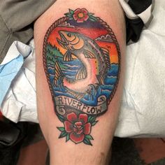 a man with a tattoo on his leg that has a fish in the center and words river lion