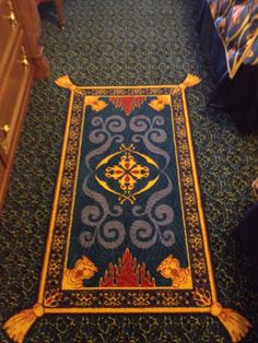 a blue and yellow rug on the floor in a room