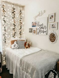 a bedroom decorated with lights and pictures on the wall, including a small child's bed