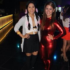 two women in shiny outfits posing for the camera