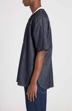 Designed as part of the fashion house's Palermo collection, this softly oversized bowling shirt is cut from indigo-dyed denim and boasts a rope-style back logo. Front snap closure Crewneck Elbow-length sleeves Curved hem 100% cotton Machine wash, line dry Made in Italy Designer Clothing Relaxed Fit Denim Shirt With Spread Collar, Unstructured Denim Blue Top, Dark Wash Relaxed Fit Collared Denim Top, Dark Wash Collared Relaxed Fit Denim Top, Dark Wash Relaxed Fit Denim Top With Short Sleeves, Indigo Denim Short Sleeve Shirt, Indigo Short Sleeve Denim Shirt, Classic Indigo Denim Top Relaxed Fit, Classic Indigo Denim Top With Relaxed Fit