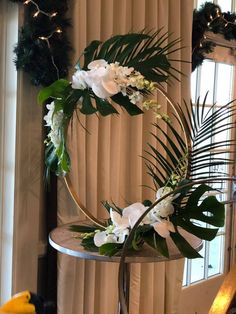 a table with flowers and greenery on it