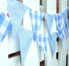 blue and white gingham bunting hanging on a fence