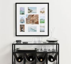 there is a wine rack with bottles and glasses on it next to a white wall