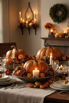 a table set for thanksgiving with pumpkins and candles