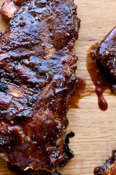 ribs covered in bbq sauce on a cutting board