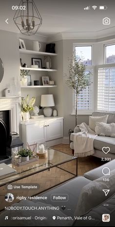 a living room filled with furniture and a fire place in front of a tv mounted on a wall