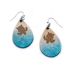 Introducing the perfect summer accessory for the beach and sea turtle lovers alike! These beautiful beach patterned earrings feature the serene blue waves of the sea gently lapping onto a sandy shore, laser cut and engraved with a charming turtle design. No 2 pair will be exactly the same as the pattern varies slightly,. Crafted with the utmost care and attention to detail, these earrings are both lightweight and hypoallergenic, ensuring comfortable wear for hours on end. The teardrop shape and Hypoallergenic Teardrop Earrings For Beach, Turtle Design, Blue Waves, Earring Patterns, Summer Accessories, Summer Jewelry, Perfect Summer, Sea Turtle, Summer Beach