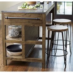 a kitchen island with two stools next to it