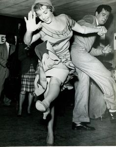 an old black and white photo of people dancing